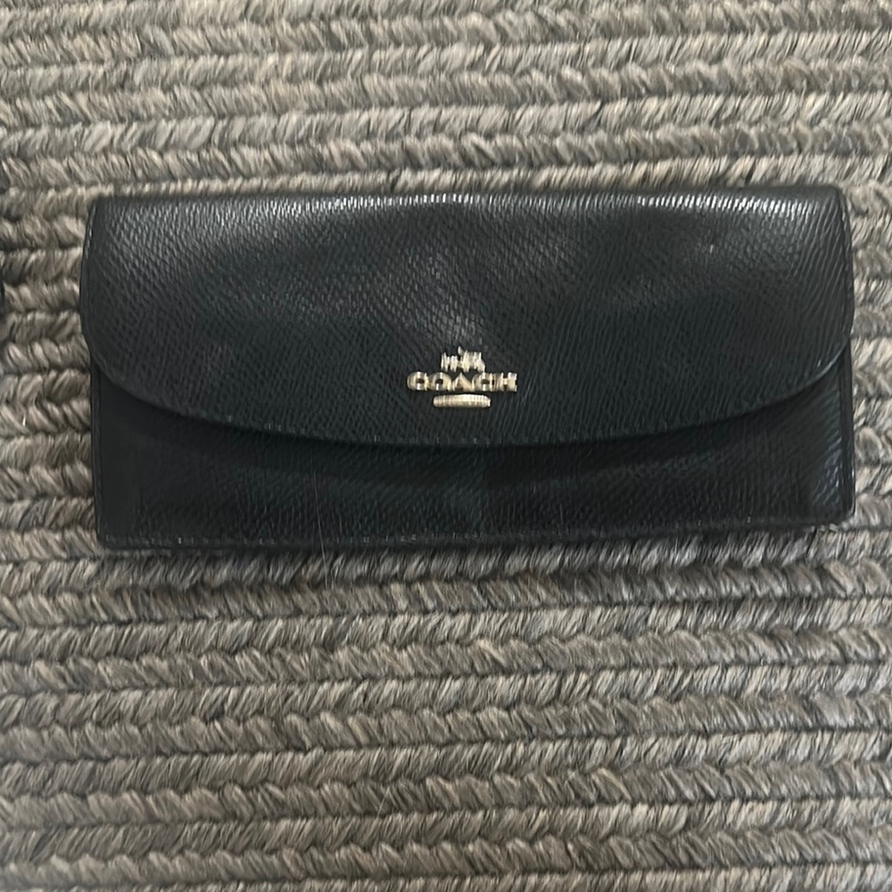 Black full size wallet . Coach. Great piece . Been stored in a tote.